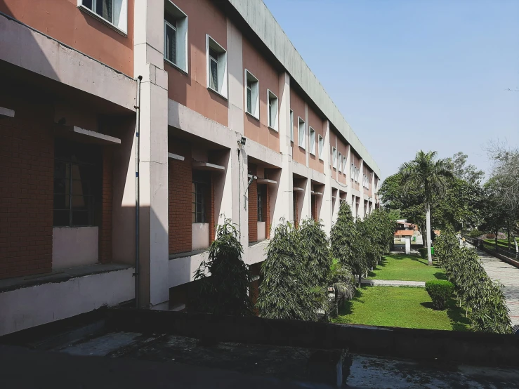 an apartment building with a small garden on the lawn