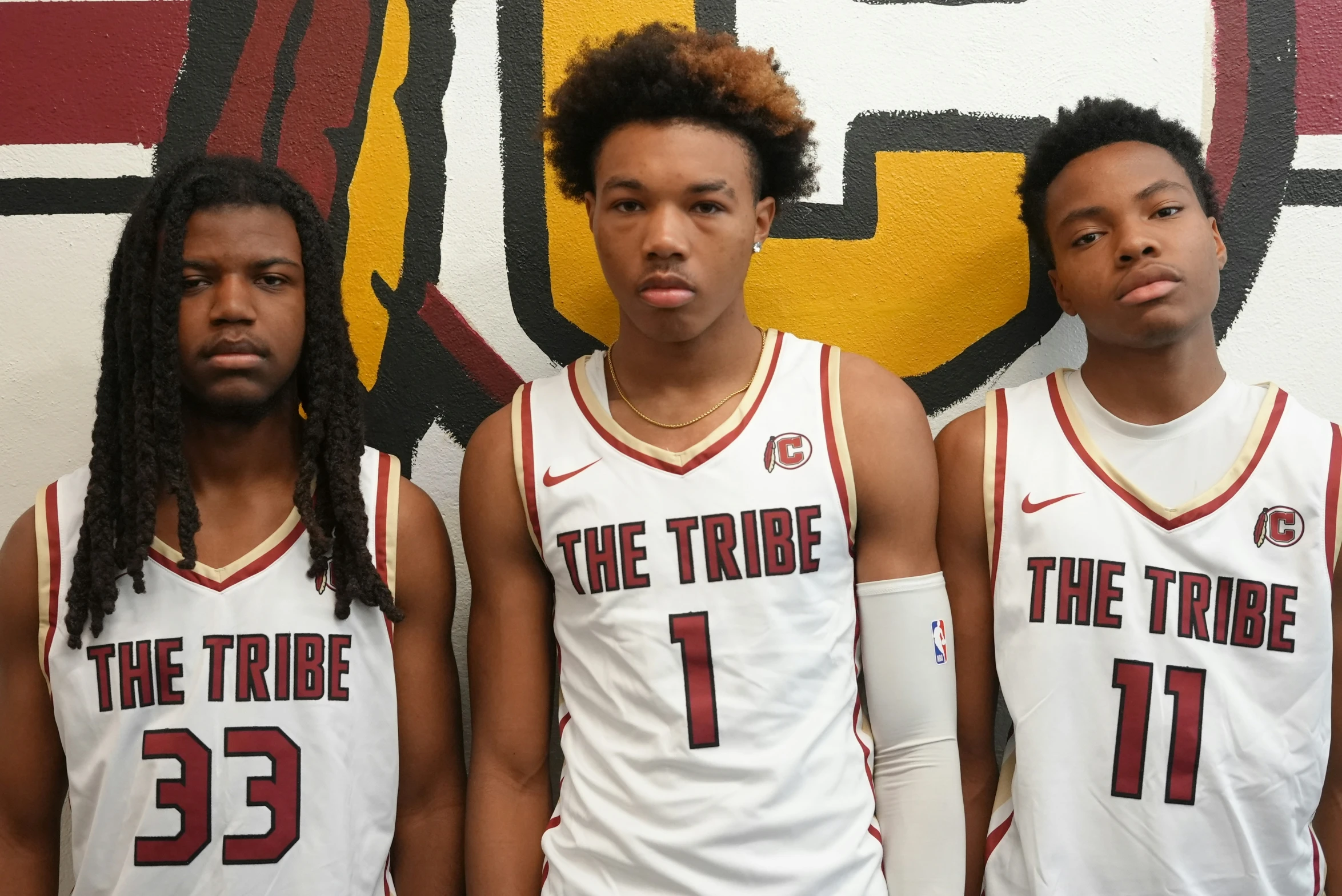 three basketball players are posing for a po