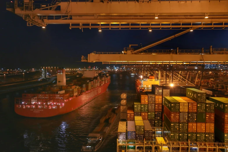 a cargo ship and many other boats in the harbor