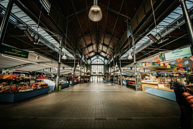 an indoor market with fruits and vegetables inside