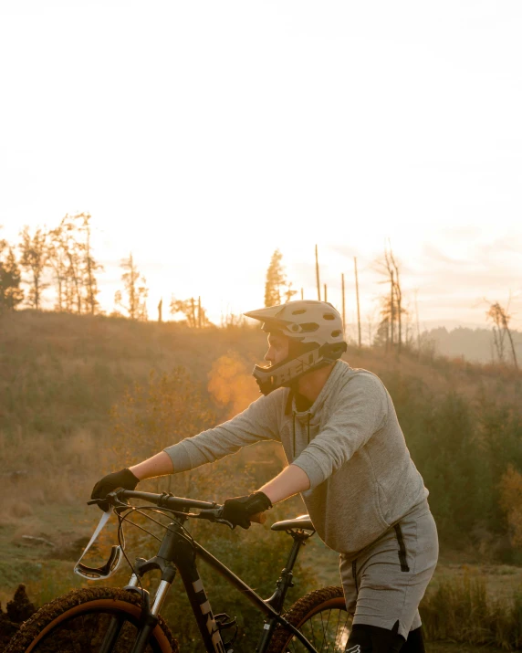 a man riding his bicycle through the woods