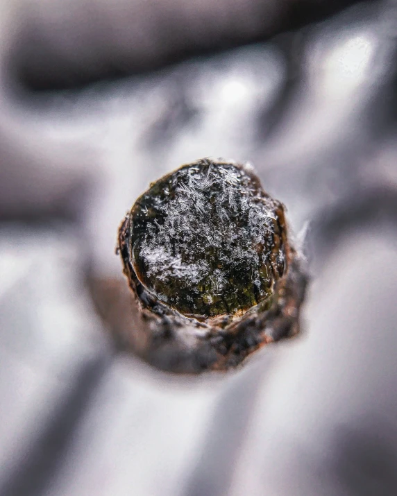 a close up of a round substance in the snow