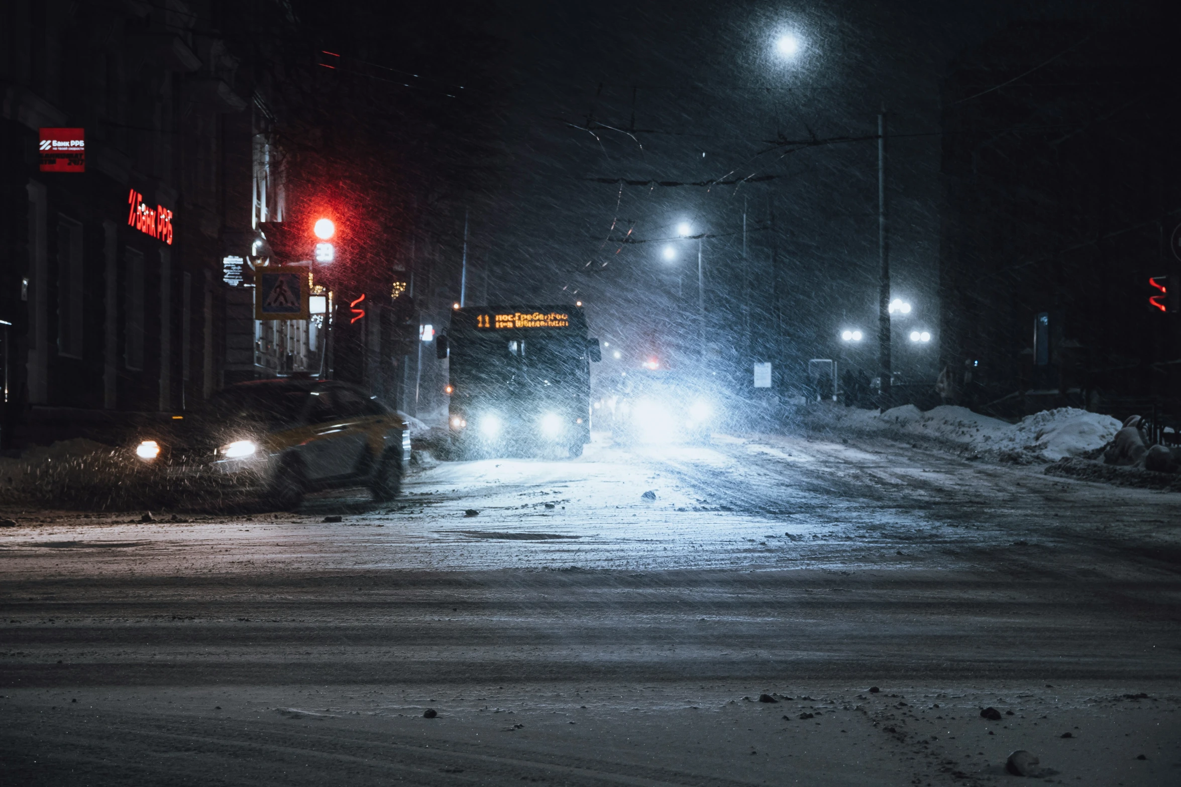 a couple cars stopped on a snow covered road