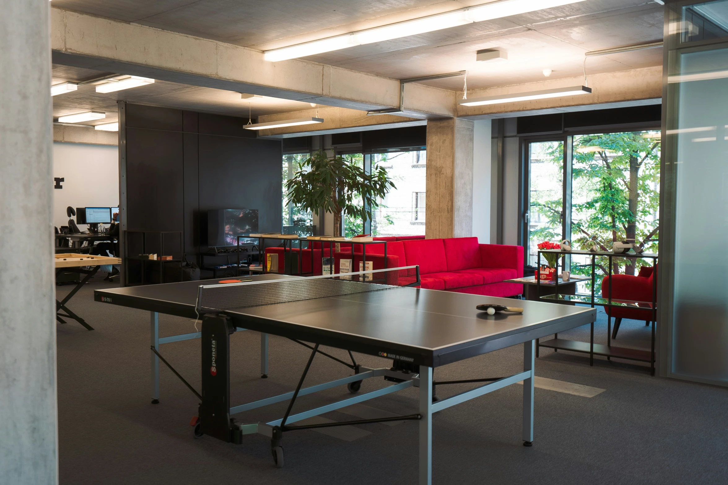 an office with a ping pong table set up