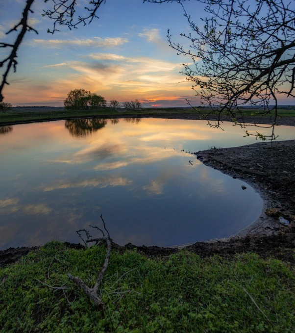 the water is very shallow near the shore at sunset