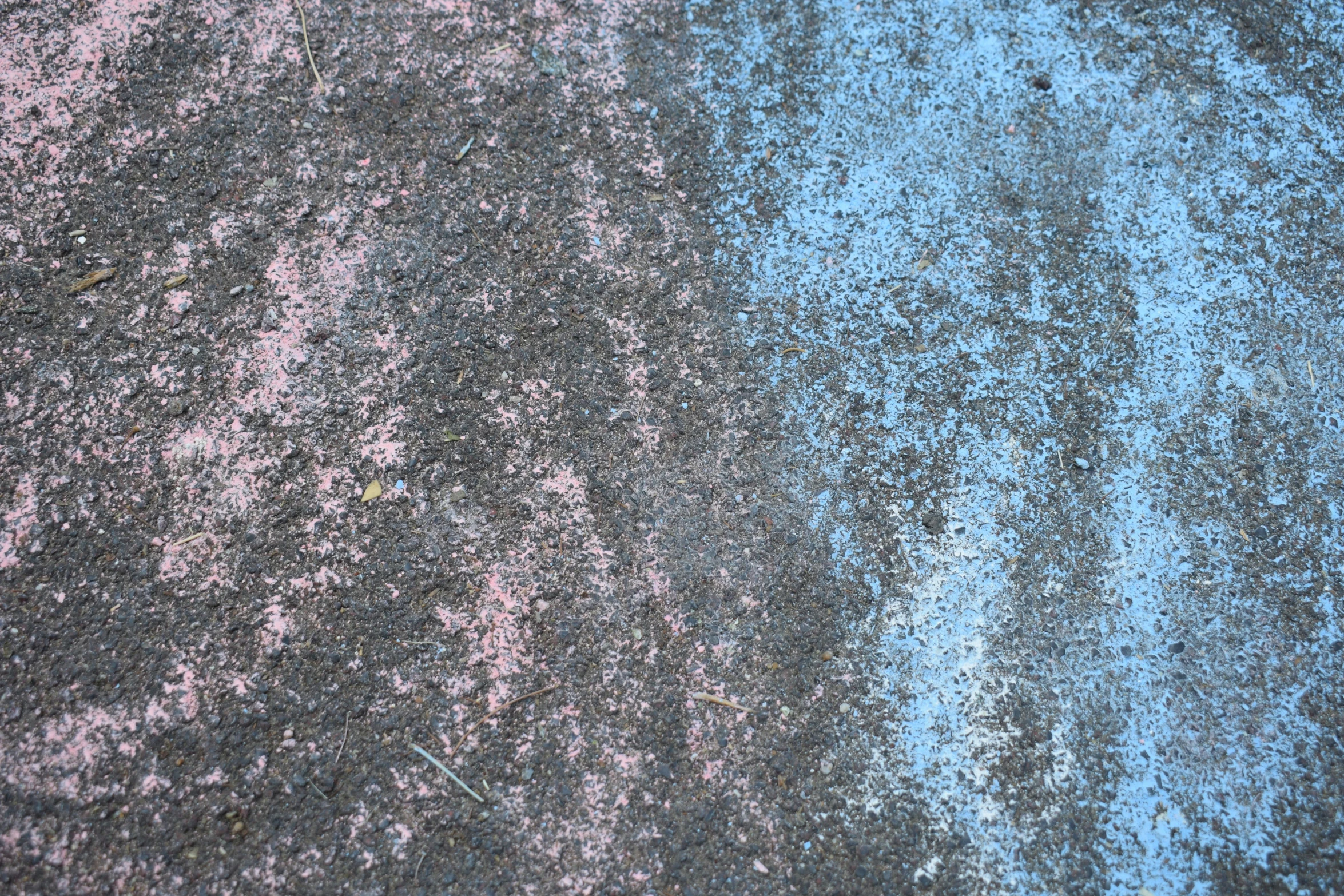 a close up of a worn and faded sidewalk