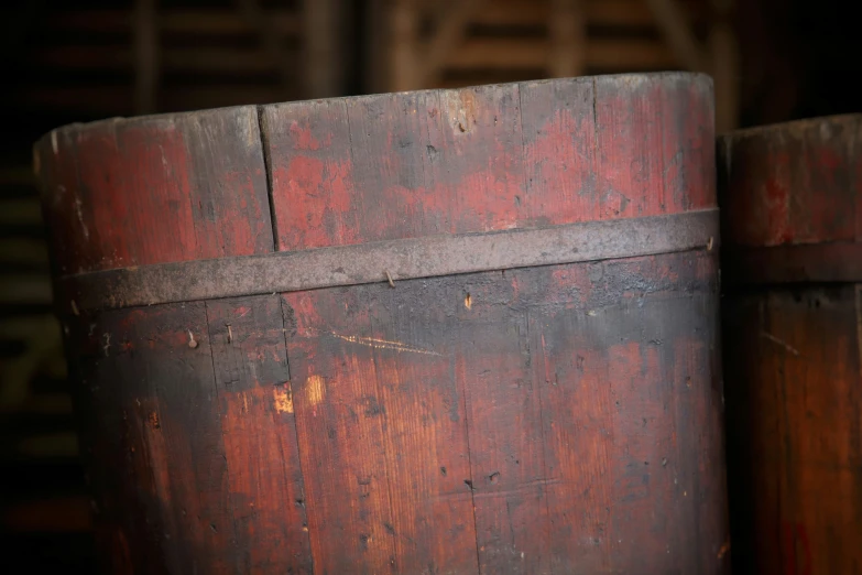 a rusted barrel with a piece of wood sitting on top