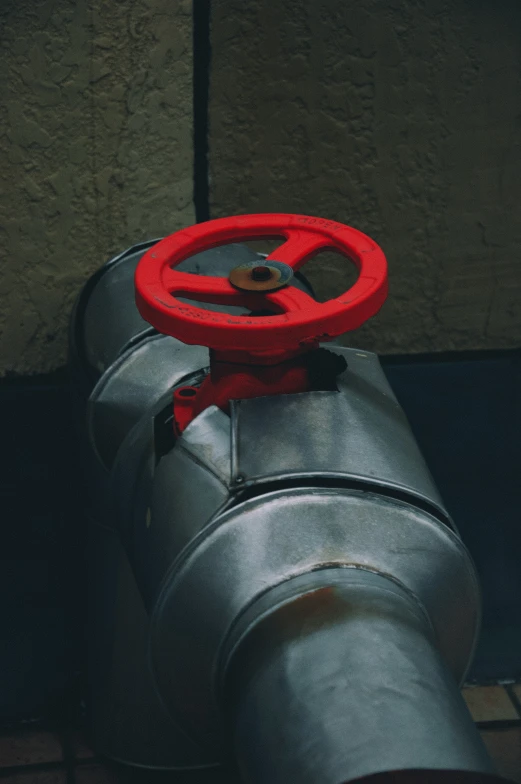 a large metal object that looks like a red steering wheel