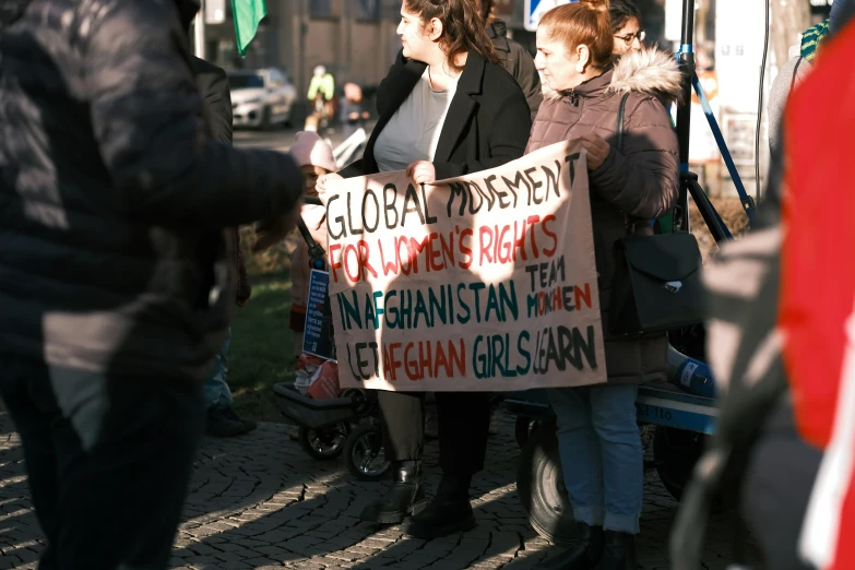 a group of people are holding signs for the political campaign