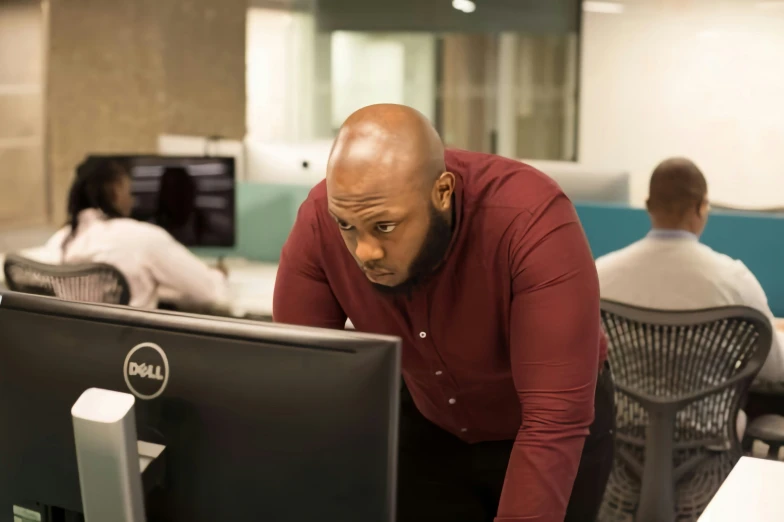 the man is looking at the computer screen