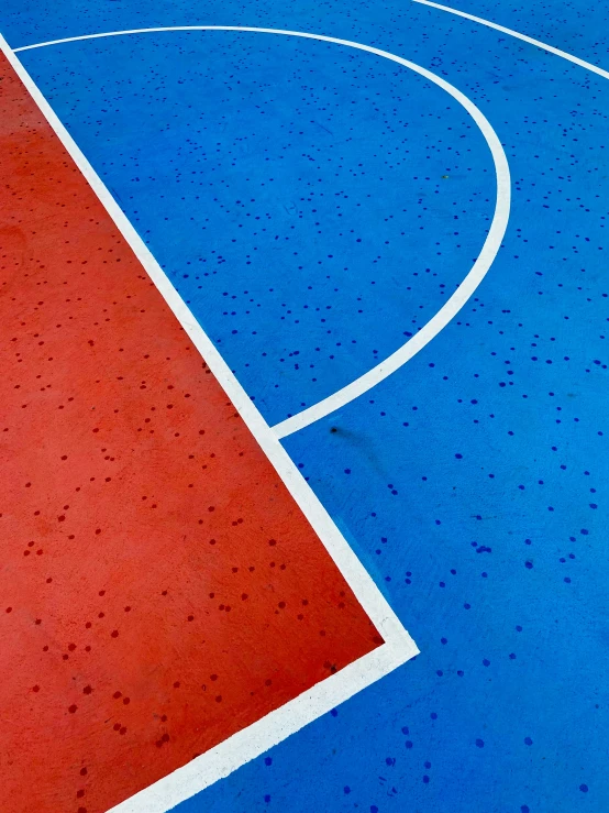 a basketball court has blue paint and orange rims