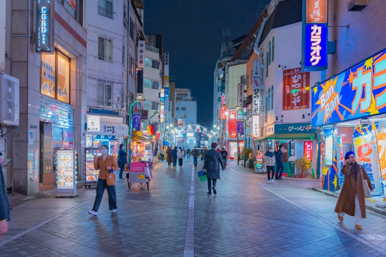 a busy street with lots of neon signs in it