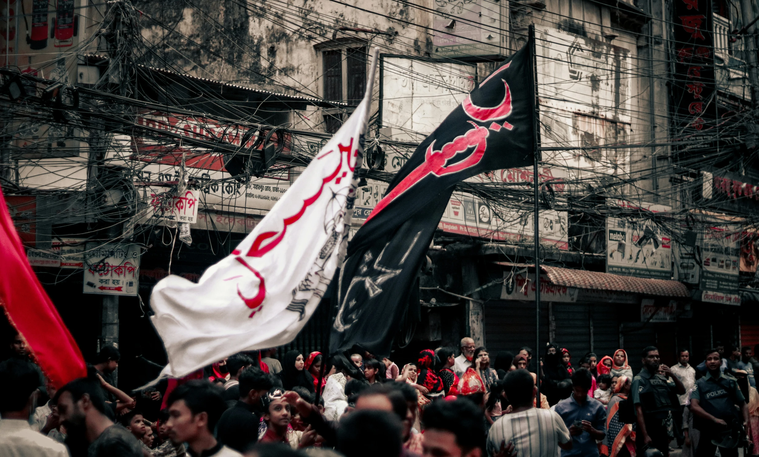 some people on some buildings holding up red and white banners