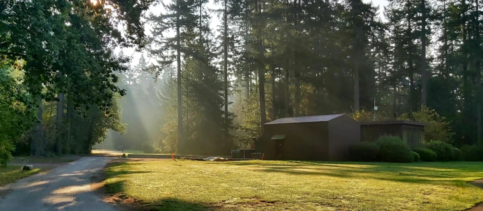 a small house sitting in the middle of a lush green park