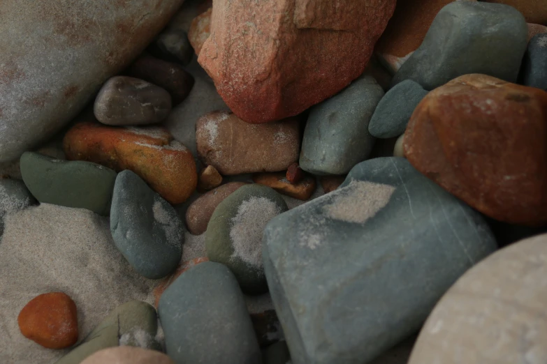 many different colors rocks and one large rock