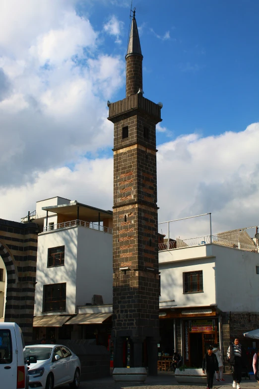 a tall tower with a clock on top on a street