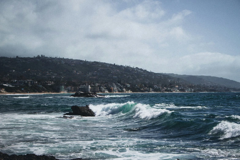 a body of water with waves crashing against a shore