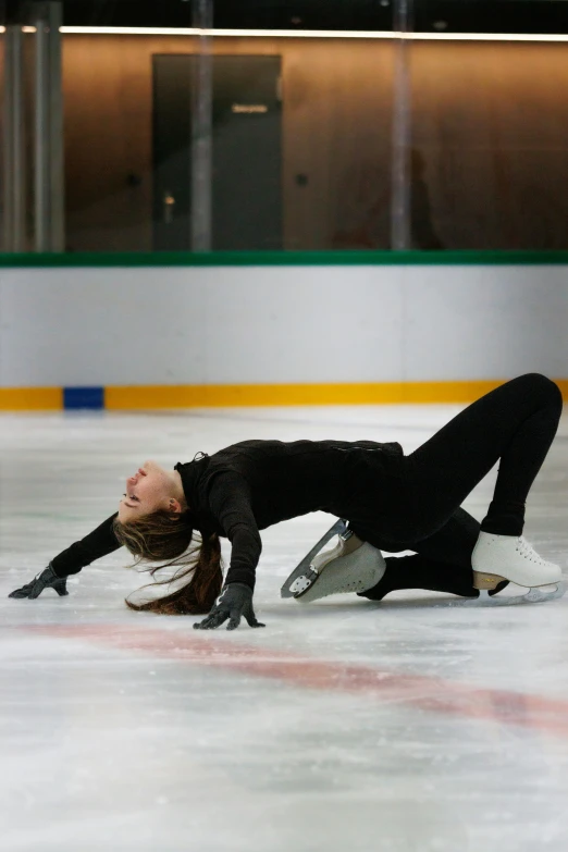 a female figure skating around on an ice rink