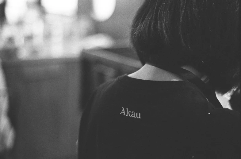 a girl wearing a shirt that says alka