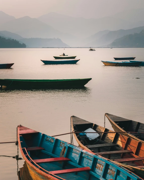 the boats are on the water near the shore