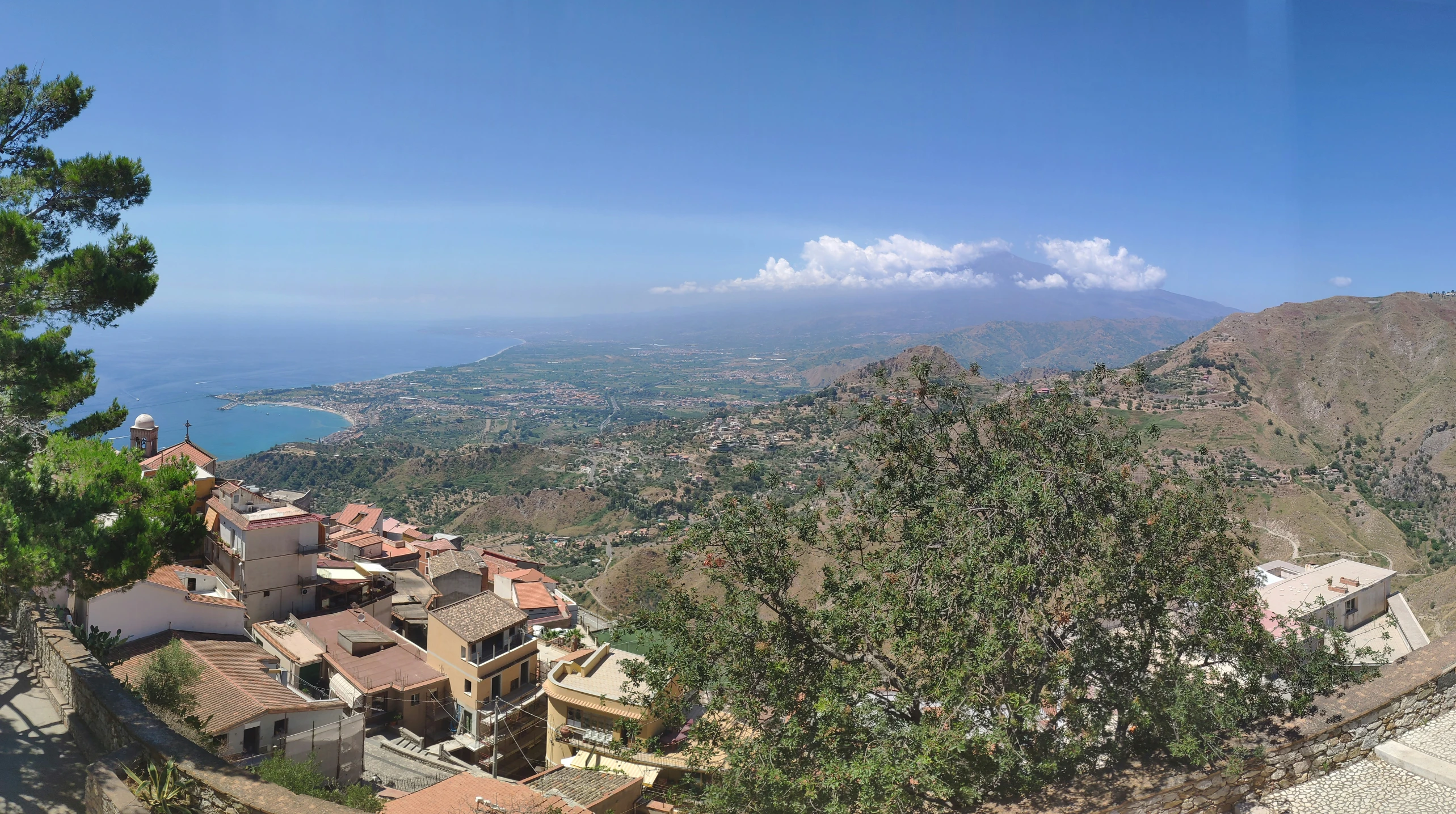 a town with mountain scenery on a sunny day