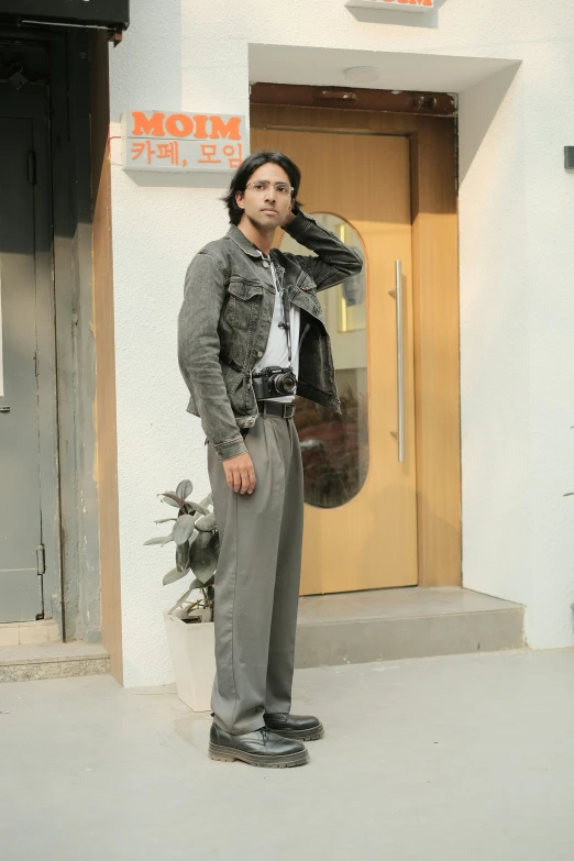 a man is standing in front of the entrance of a store