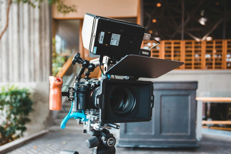 an open camera with video equipment on a tripod