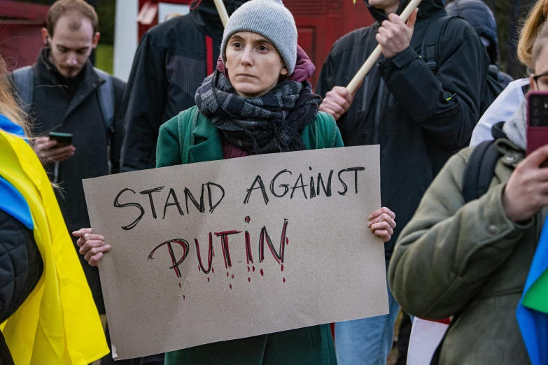 a person holding a sign with words on it