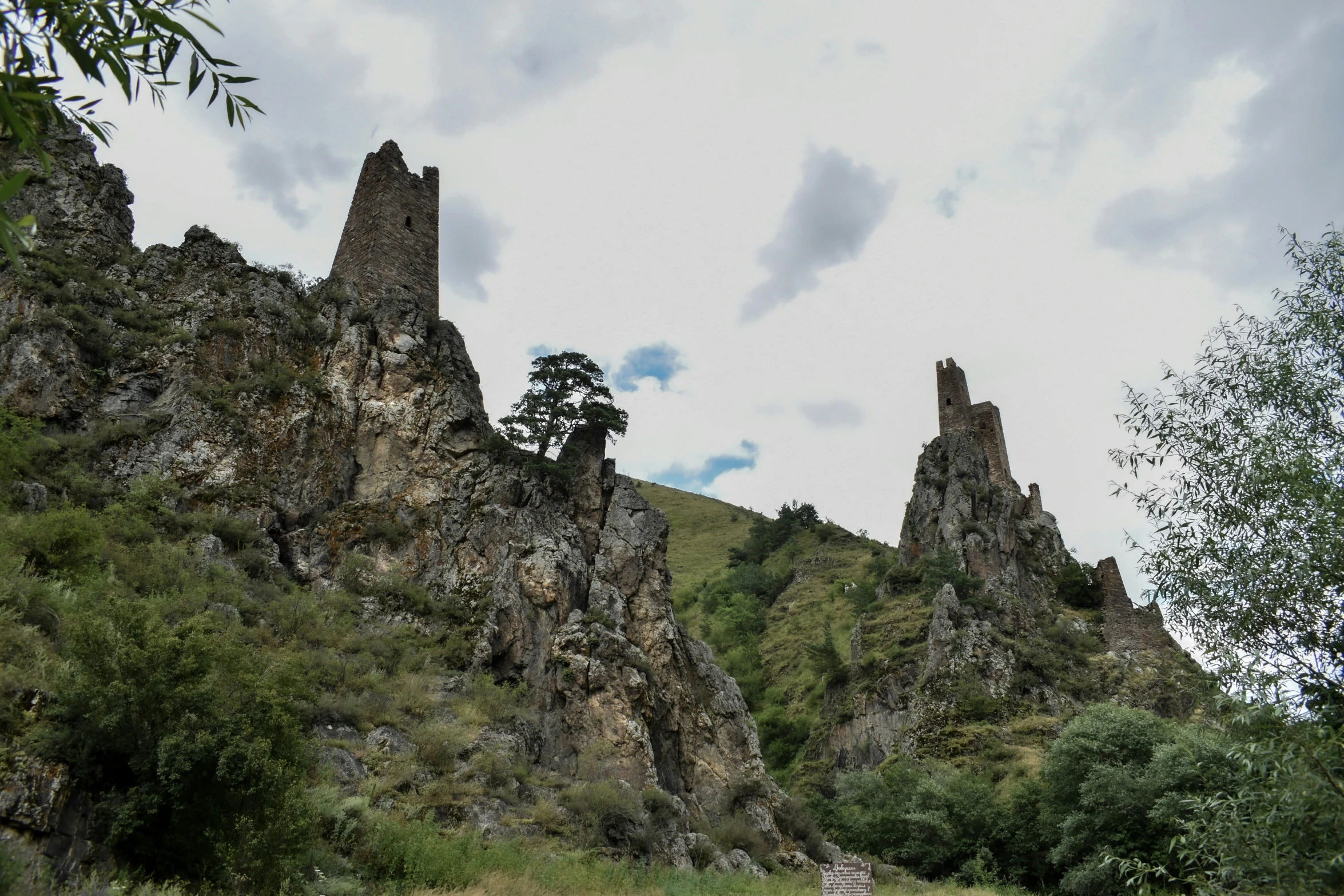 some rocky mountain side towers with trees