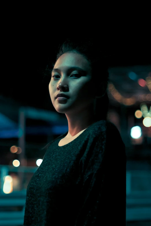 a woman with black makeup and eyeshadow standing in a street