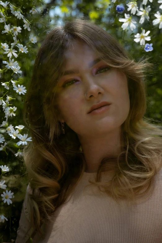 a woman is posing in front of flowers