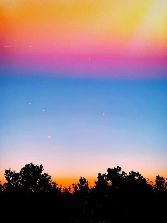 the moon and venus are seen in this dusk sky