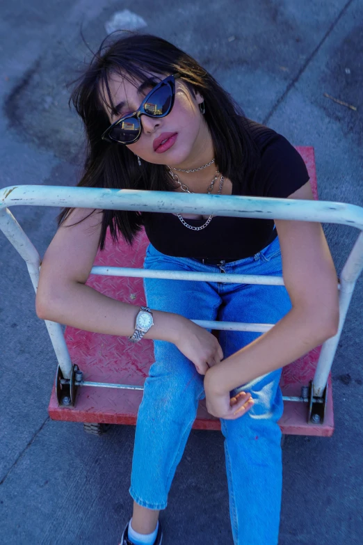 a girl sitting on a small red chair