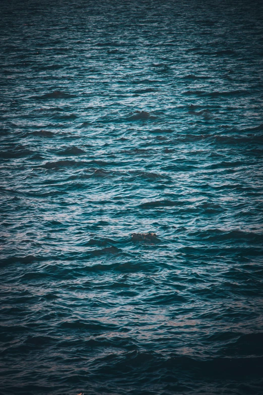 a large body of water with several lines of land in the distance