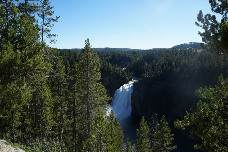 a view of a waterfall with some trees around it