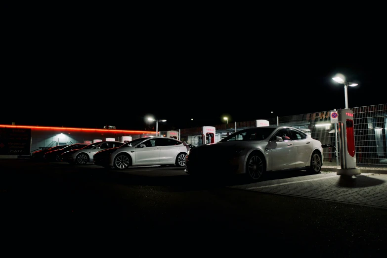 a car at a gas station with all the lights on