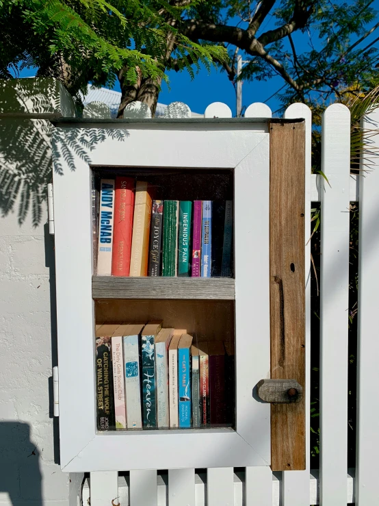 an old book case that looks like a white fence