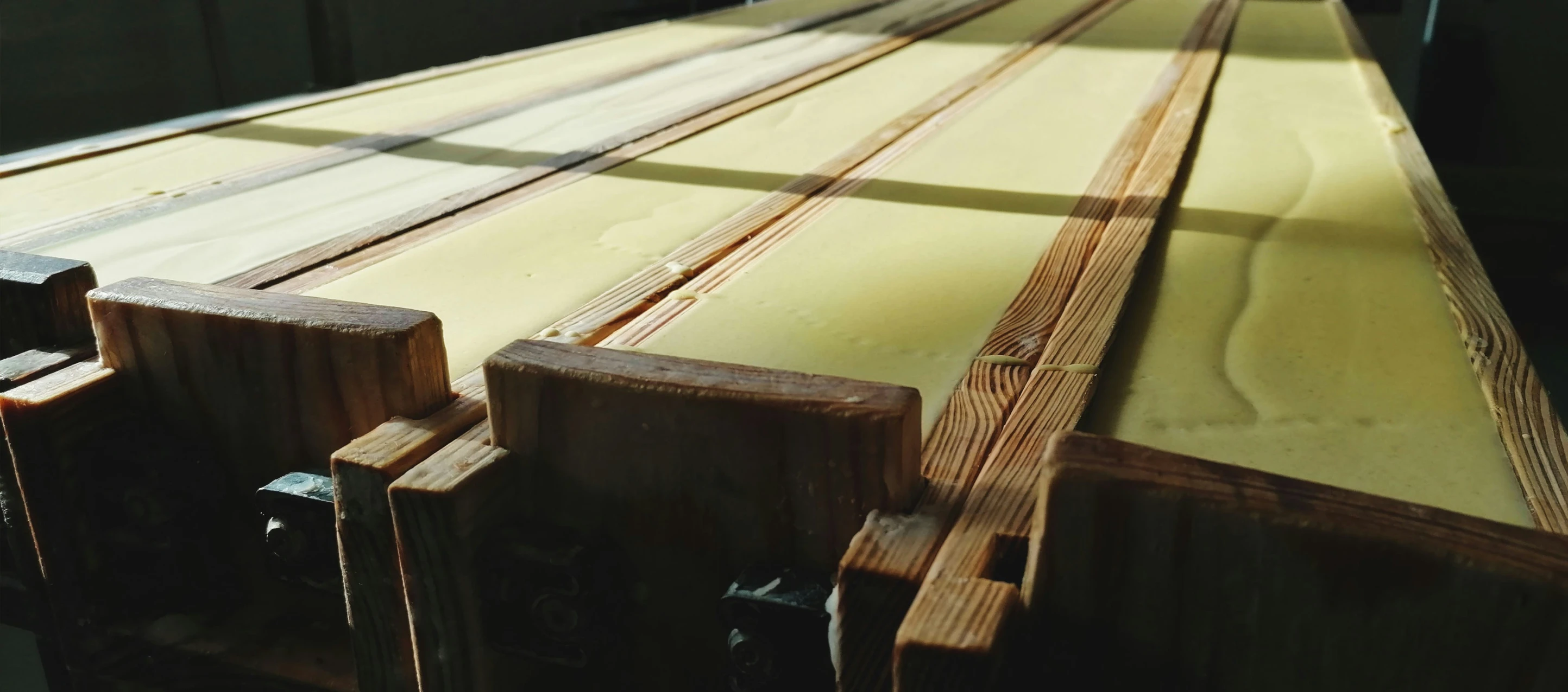 a row of wooden planks waiting to be assembled