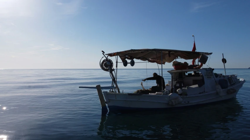 people sitting on the deck of a small boat