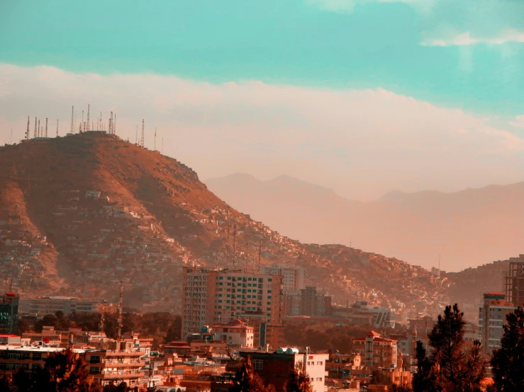 an image of a city skyline with mountains in the background