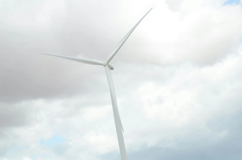 two people on horses and a wind turbine