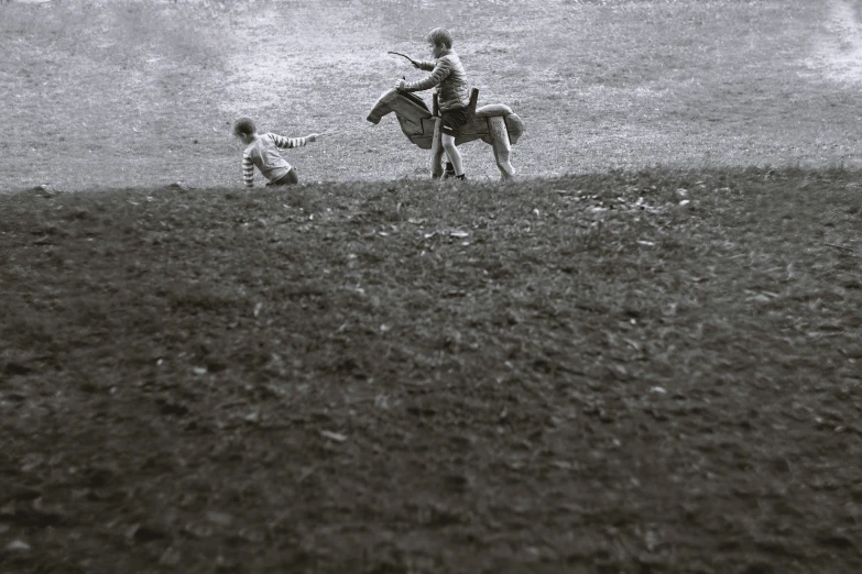 a cowboy riding on the back of a horse in a field