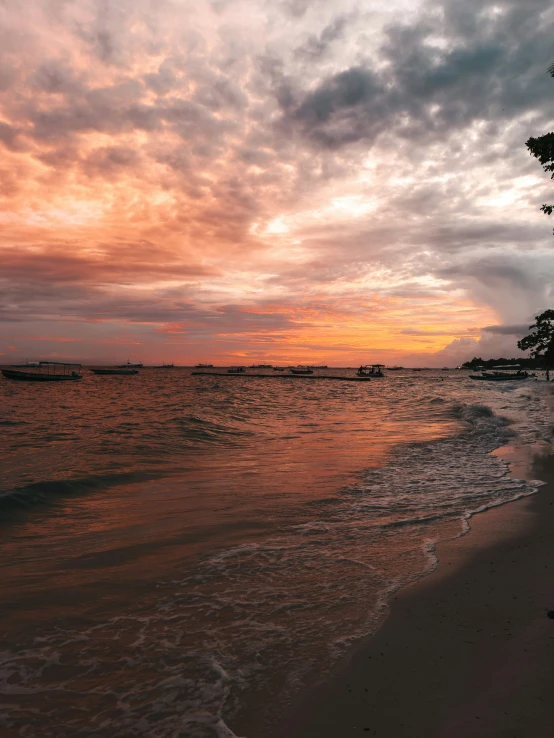 two boats out in the water during sunset