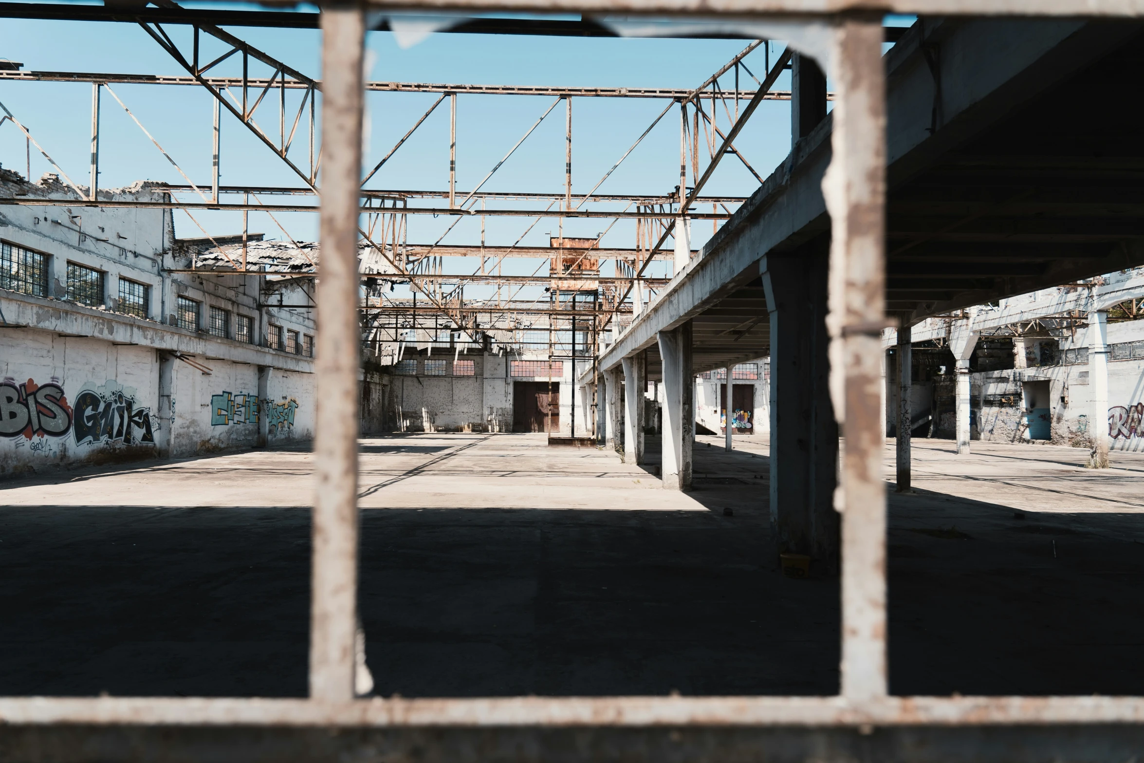 the view out of a broken window of an abandoned building