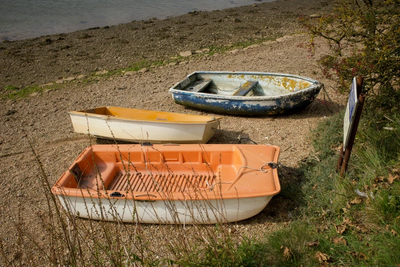 a couple of canoes sitting on the side of a beach