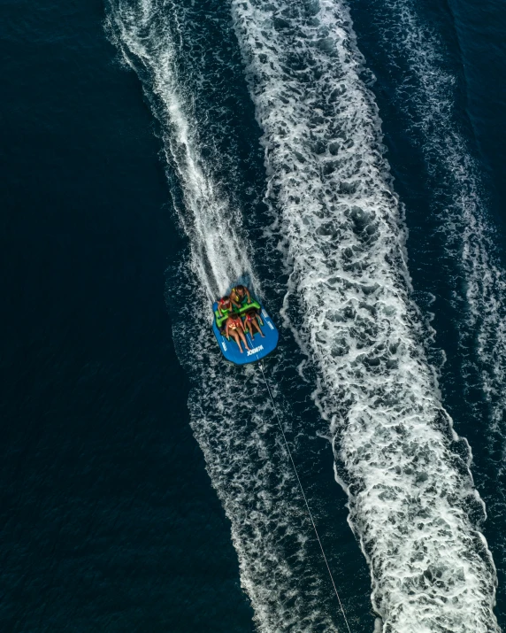 a group of boats moving along a large body of water