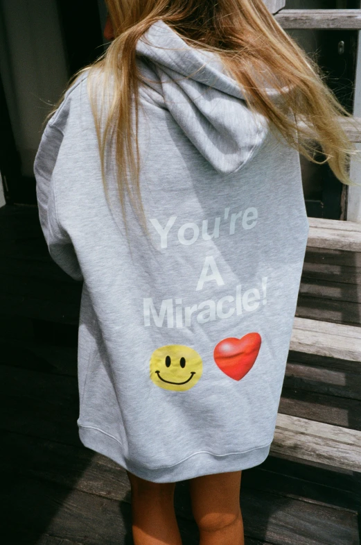 the back of a 's sweatshirt with smiley faces on it