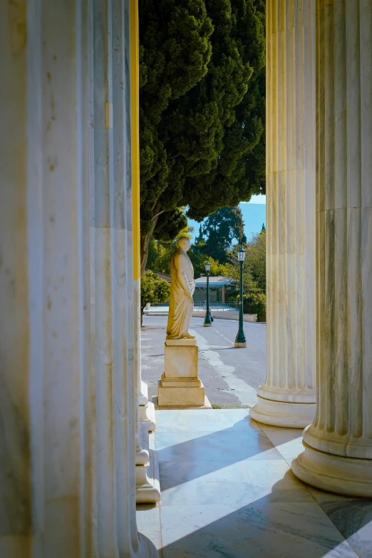 there is a statue of an individual at the end of a walkway