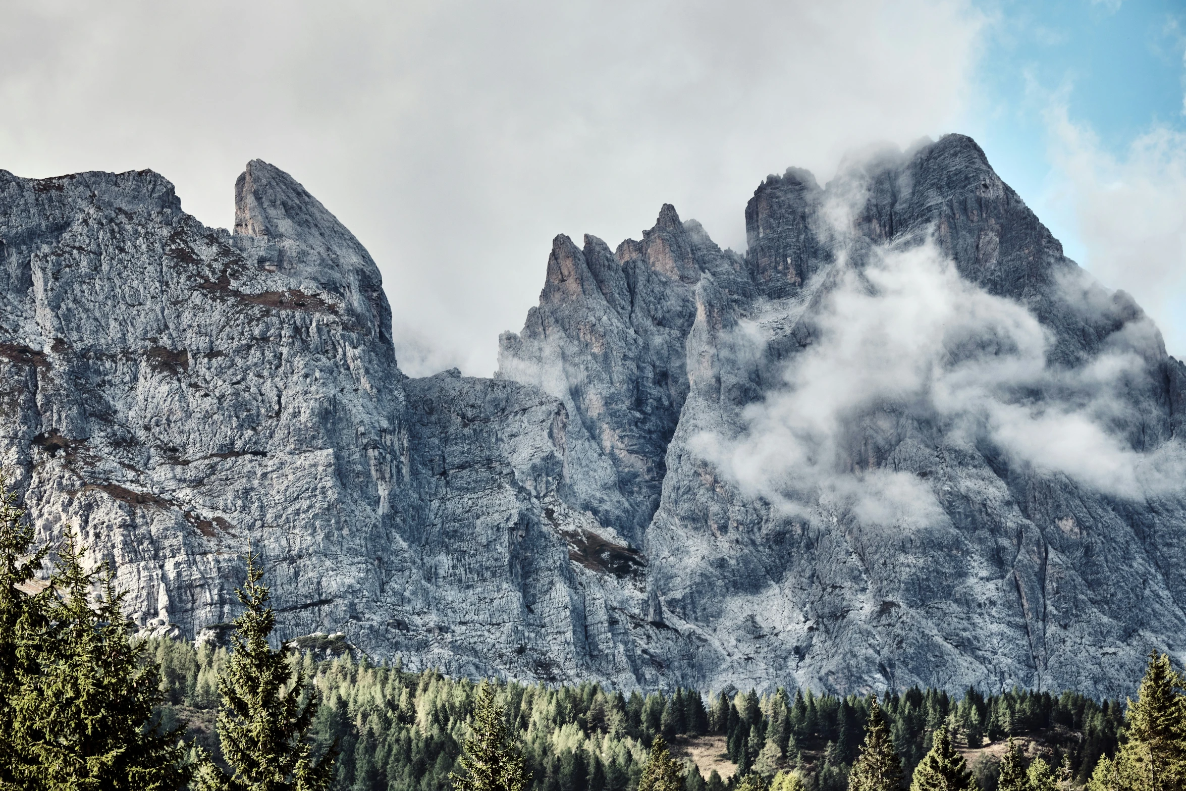 mountains and clouds rise up on a cloudy day