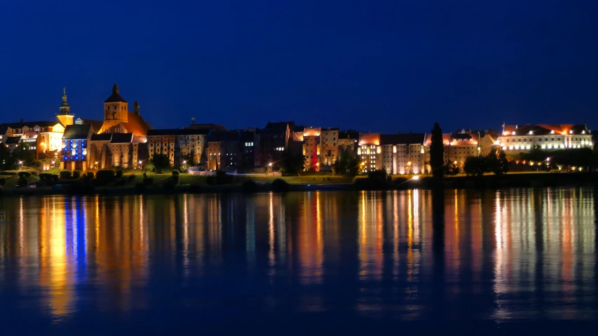 night time reflection of buildings along the water